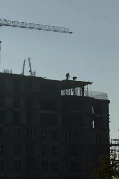 Construction crew members building condominium for new residential district Stock Photos