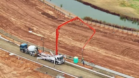 Construction crew operating concrete pumper at new residential site Stock Footage 278300732