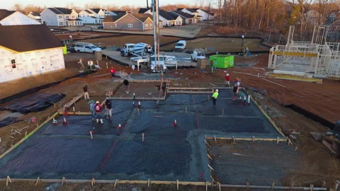 Construction Crew Pouring A Concrete Slab Foundation For A New Home. - aerial Stock Footage 338170203