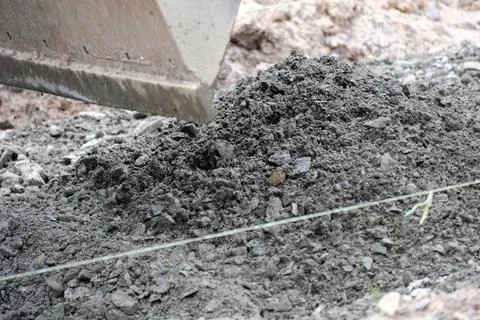 Construction crew prepares foundation at a busy building site Stock Photos