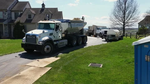 Construction crew preparing residential backyard pool with Mack truck and Stock Footage 333397199