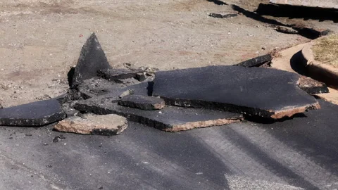 Construction crew removes asphalt using skid steer loader in parkin lot Stock-Footage 337497396