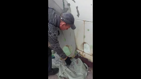 Construction crew removes sheet of drywall and prepares for new installation at Stock Footage 335240814
