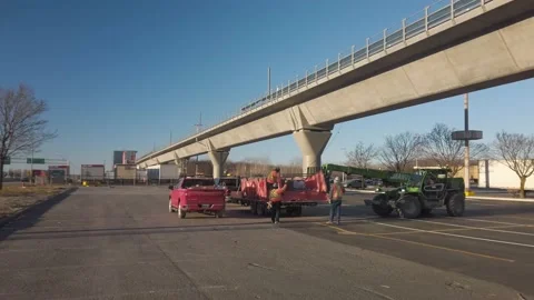 Construction Crew Unloading Material from Crane Stock Footage 230693882