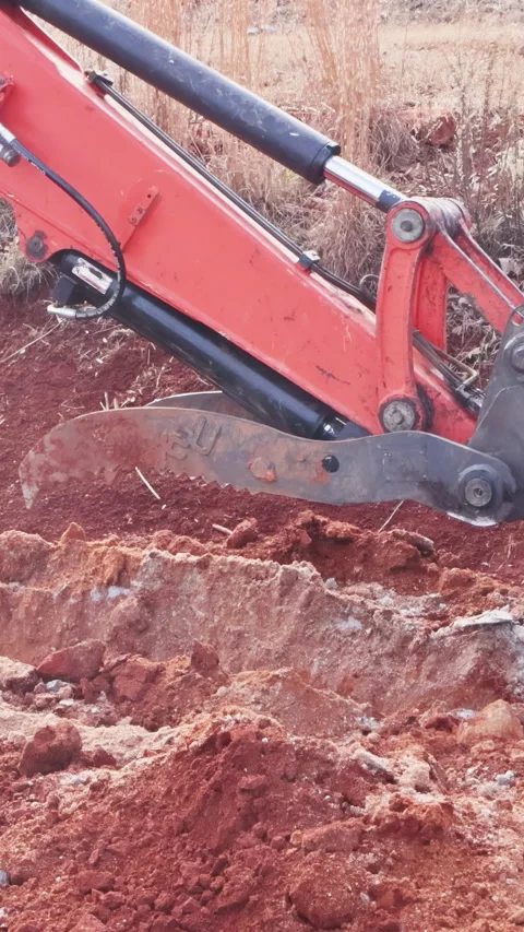 Construction crew uses digger to excavate soil, create trench at work site Stock Footage 342619218