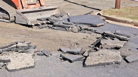 Construction crew uses heavy machinery to remove asphalt in parking lot Stock-Footage 337740316