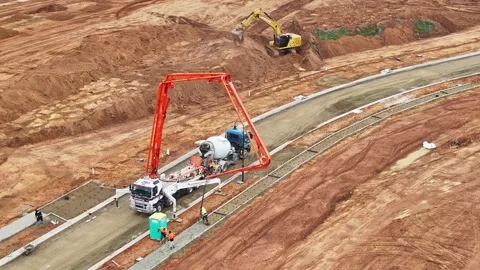 Construction crew using concrete pumper for building a path Stock Footage 278300721