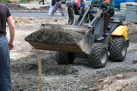 Construction crew working to build a new road with heavy machinery Stock Photos