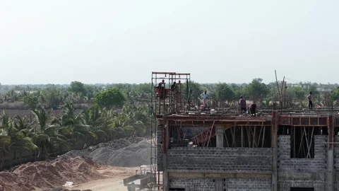 Construction Crew Working on Building Rooftop at Industrial Development Site in Stock Footage 344091810