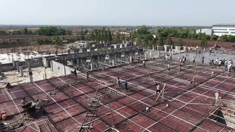 Construction Crew Working on Building Slab Reinforcement at Industrial Site in Stock Footage 344091772