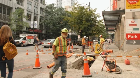 Construction Crew Working on Laying Pipe in Trench Under Concrete Vancouver Stock-Footage 94048672