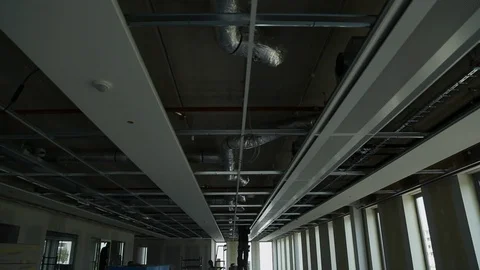 Construction Crew Working on an Office Ceiling Under Construction Stock Footage 95847441