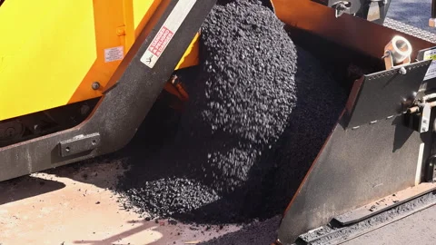 Construction crew works on road as asphalt is laid down using paving machine Stock Footage 342949699