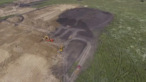 Construction crews prepare a site for a building. Aerial flight over earth Stock Footage 86535400