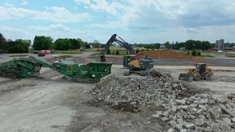 Construction Crews Work on a Site With Heavy Equipment Moving Rocks and Deb.. Stock Footage 335652202