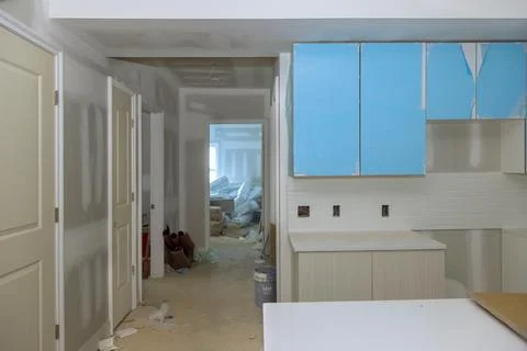 Construction of custom modular kitchen cabinets in a new house Stock Photos
