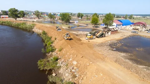 Construction of a dam made of earth and sand. The edge of the earth near the Stock Footage 155465688