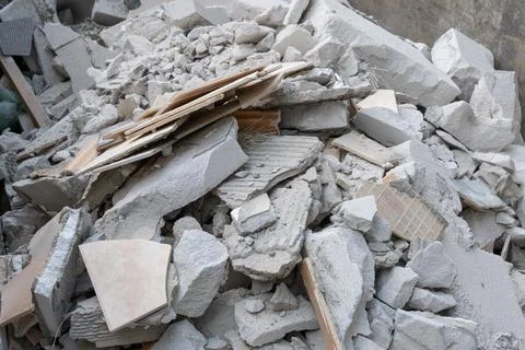 Construction debris and broken ceramic tiles inside metal dumpster containe.. Stock Photos