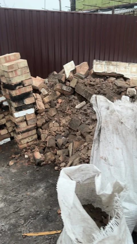 Construction debris from the dismantling of an old heating stove. Bricks an.. Stock Footage 329439267