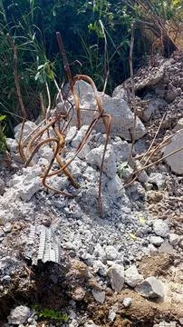 Construction Debris Scattered in an Open Area After Demolition Activities N.. Stock Photos