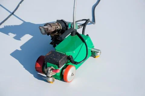 Construction device for installing waterproofing materials on the roof Stock Photos