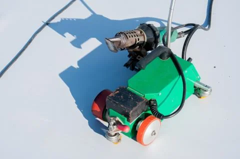 Construction device for installing waterproofing materials on the roof Stock Photos