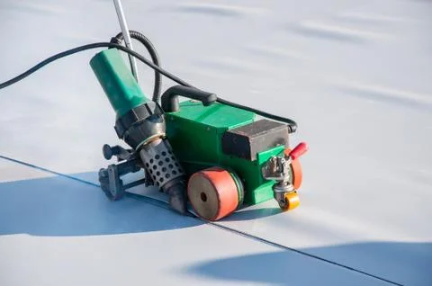 Construction device for installing waterproofing materials on the roof Stock Photos