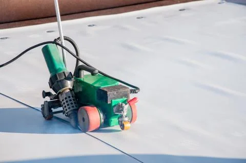 Construction device for installing waterproofing materials on the roof Stock Photos
