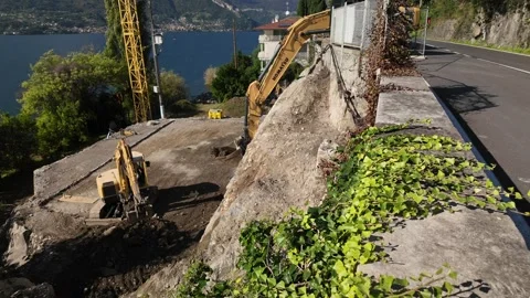 Construction diggers working by Lake Como Stock Footage 318313549