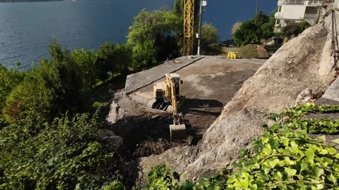 Construction diggers working together by Lake Como Stock Footage 318313441
