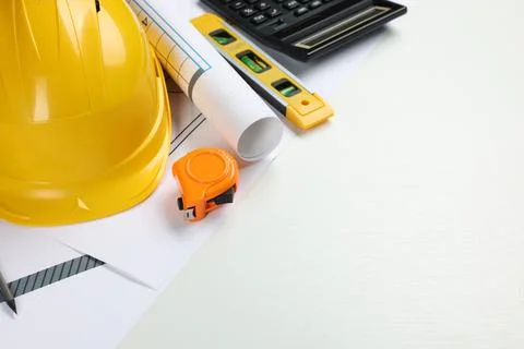 Construction drawings, safety hat, calculator, tape measure and bubble level  写真素材
