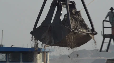 CONSTRUCTION DREDGING: Giant scoop lifts sand and mud from river to barge Video stock 35733523