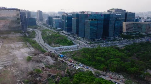Construction dust with glass facade buildings, traffic flow and ITC Kohenur at Video stock 343031940