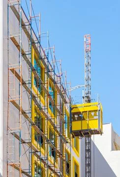 Construction elevator cabin for lifting workers Stock Photos