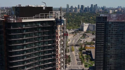 Construction Elevator Descending Along Downtown Highrises Stock Footage 327370663