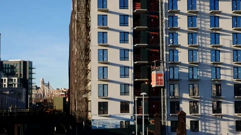 Construction elevator going up the side of a new residential building Stock Footage 146351455