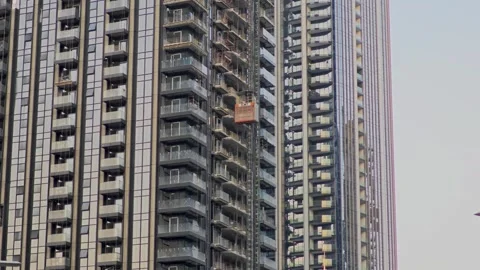Construction elevator going up a skyscraper under construction Stock Footage 321640213