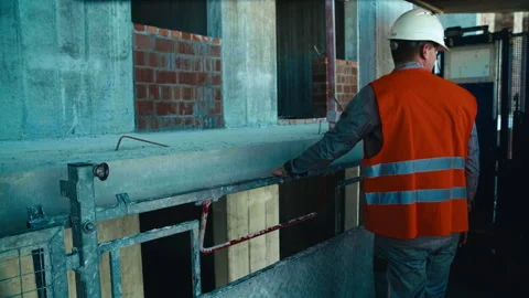 A construction elevator moves along the outside of an unfinished building Stock Footage 271331607