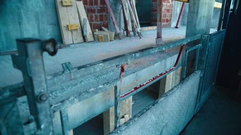 A construction elevator moves along the outside of an unfinished building Stock Footage 271331749