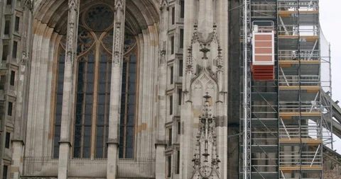 A construction elevator is moving upwards at an old churchtower Stock Footage 114806263