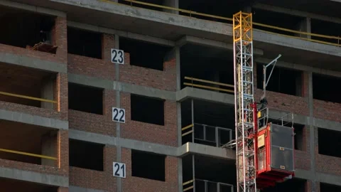 Construction elevator with workers in lifting up. Stock Footage 194973075