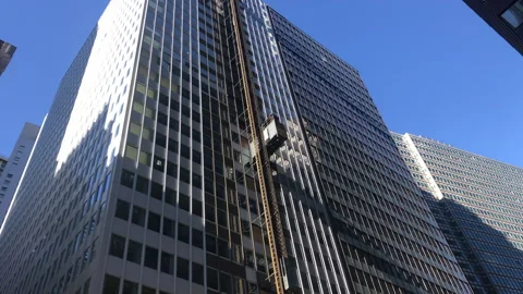 Construction Elevators Travel Up and Down on Outside of Building Stock Footage 254848012