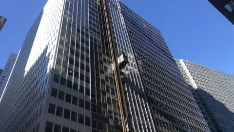Construction Elevators Travel Up and Down on Outside of Building Stock Footage 254849096
