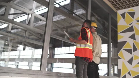 Construction Engineer and Architect discussion Plans And Blueprints Stock Footage 159952824