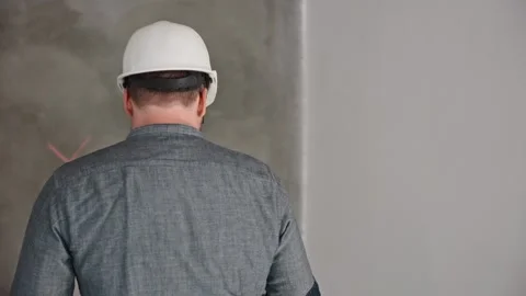 A construction engineer and a foreman inspect the construction site and discuss Stock Footage 297050826