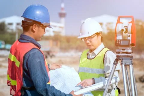Construction engineer and foreman worker checking construction drawing Stock Photos