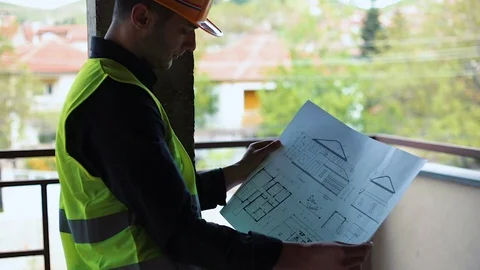 Construction engineer architect holding office blueprints against pillar Stock Footage 129444881