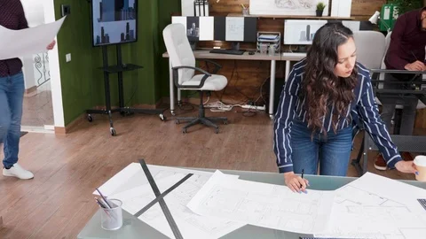 Construction engineer arriving at the office with blueprints Stock Footage 117227124