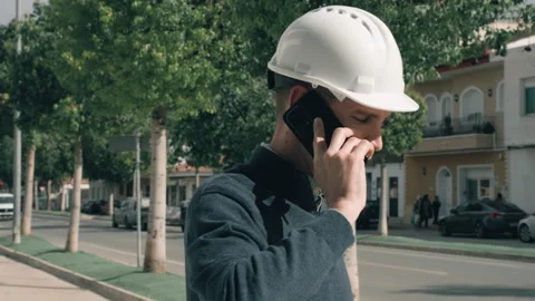 Construction engineer on city street, talk on phone, solving problems and c.. Stock Footage 329642996