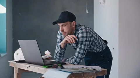 A construction engineer at a construction site works with projects using a Stock Footage 294161857